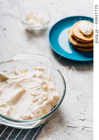 Bowl of cream cheese homemade in glass plate with pancakes and cottage cheese vertical healthy food 49847770