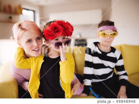 A young woman with two children having fun at home. 49848948