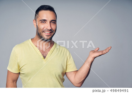 Closeup of hispanic man holding empty copy space for text or product on his palm 49849491