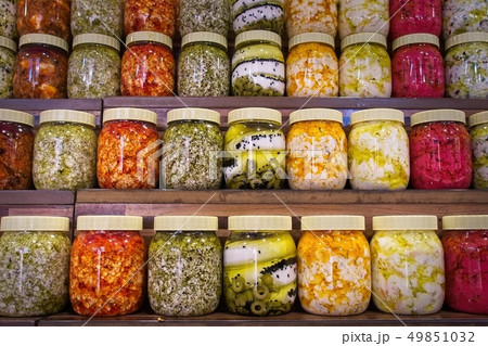 Jars with variety of pickled vegetables. 49851032
