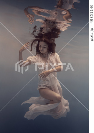 Portrait of a girl in a white dress under water Portrait of a girl in a white dress under water 49851146