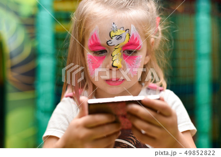 little girl with a pattern of unicorn on her face little girl with a pattern of unicorn on her face 49852822