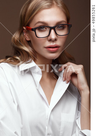 Beautiful girl in stylish clothes with glasses for vision and red sexy lips. 49855261