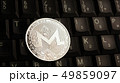 Silver Monero XMR coin on laptop keyboard 49859097