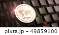 Golden ripple XRP coin over laptop keyboard 49859100