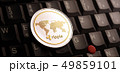 Golden ripple XRP coin over laptop keyboard 49859101