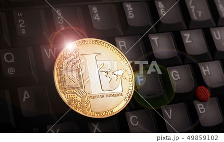 Golden litecoin LTC coin over laptop keyboard 49859102