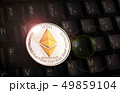 Golden Ethereum ETH coin over black keyboard 49859104