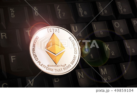 Golden Ethereum ETH coin over black keyboard Golden Ethereum ETH coin over black keyboard 49859104