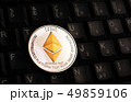 Golden Ethereum ETH coin over black keyboard 49859106