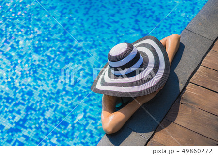 Beautiful young asian woman happy smile and relax in swimming pool 49860272