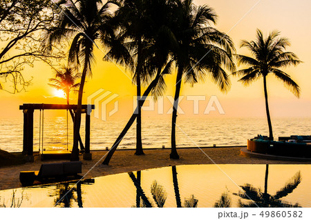 Beautiful Silhouette coconut palm tree on sky around swimming pool in hotel resort neary sea ocean beach at sunset or sunrise time Beautiful Silhouette coconut palm tree on sky around swimming pool in hotel resort neary sea ocean beach at sunset or sunrise time 49860582