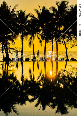 Beautiful Silhouette coconut palm tree on sky around swimming pool in hotel resort neary sea ocean beach at sunset or sunrise time 49860584