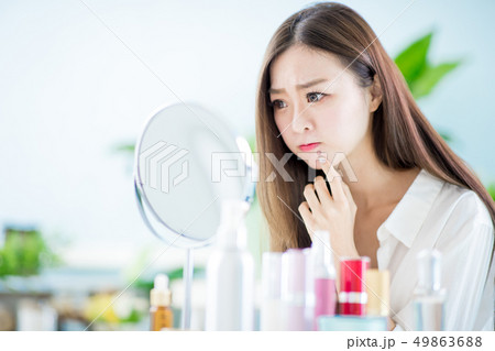 woman with acne problem 49863688