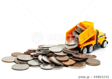 A yellow toy dump truck with pile of coins A yellow toy dump truck with pile of coins 49864242