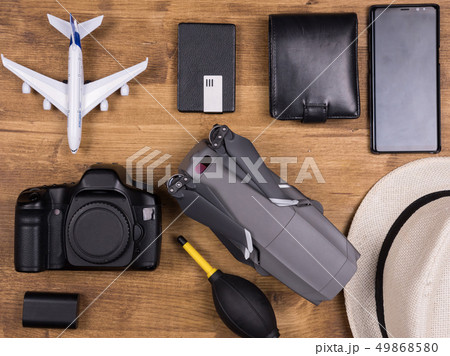 Flat lay top view of traveler accessories on white wooden background. 49868580