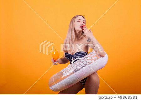 Cheerful sexy blonde woman giving kisses to the camera 49868581