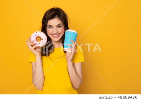 Happy excited girl with donut and coffee 49869430
