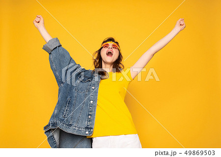 Happy screaming hipster girl holding hands up Happy screaming hipster girl holding hands up 49869503