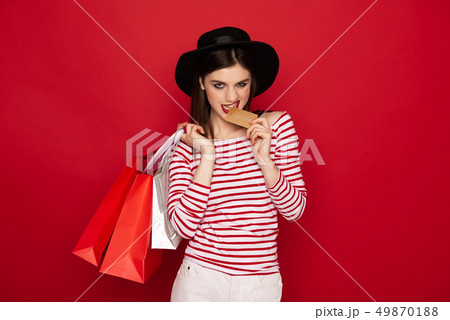 Confident lady with shopping packs and credit card 49870188