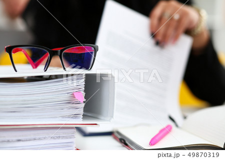 Pile of binder folders lying at worktable 49870319