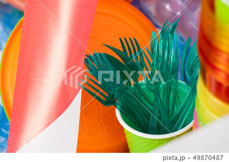 Toxic green plastic forks collected in a cup Toxic green plastic forks collected in a cup 49870487
