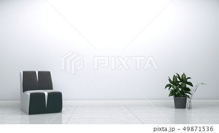 Grey armchair and plant on white wall Grey armchair and plant on white wall 49871536