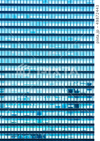 modern office building clouds reflected in window 49872443