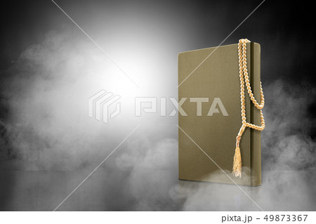 Quran and prayer beads on the table with smoke Quran and prayer beads on the table with smoke 49873367