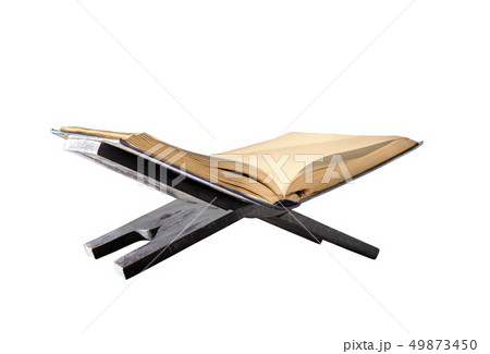 Quran open on wooden placemat Quran open on wooden placemat 49873450