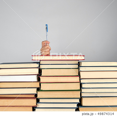 stack of different books on a gray background 49874314