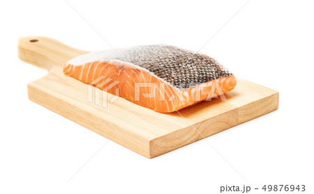 Salmon fish meat on wooden chopping block Salmon fish meat on wooden chopping block 49876943