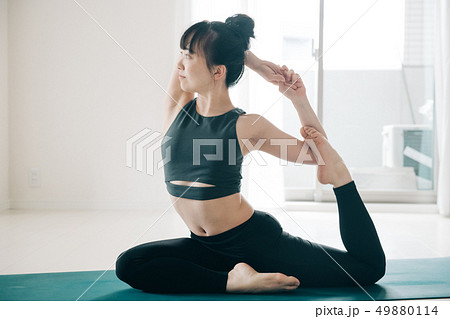 Young woman doing yoga Japanese hot yoga - Stock Photo [49880114 