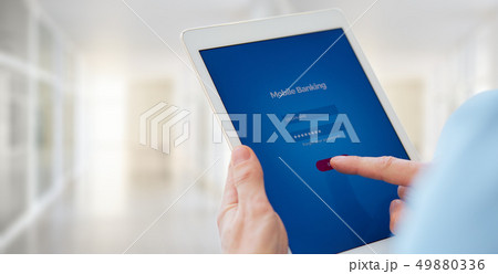 Male hands holds a tablet with online banking Male hands holds a tablet with online banking 49880336
