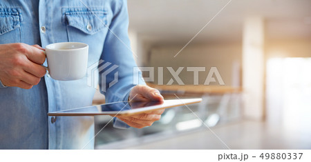 Male hands holding white digital tablet Male hands holding white digital tablet 49880337