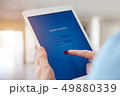 A man using online banking on a tablet 49880339