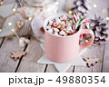 A pink mug full of cocoa with marshmallows 49880354