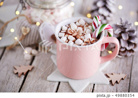 A pink mug full of cocoa with marshmallows A pink mug full of cocoa with marshmallows 49880354