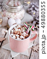A pink mug full of cocoa with marshmallows 49880355
