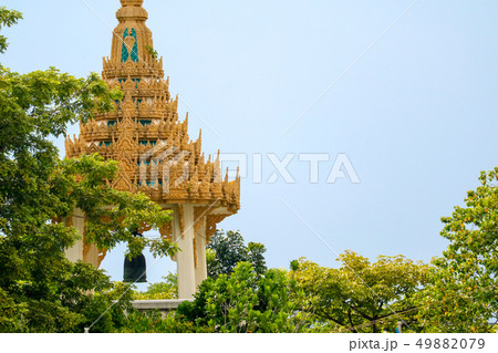 A bell tower in a temple Is covered by green trees A bell tower in a temple Is covered by green trees 49882079