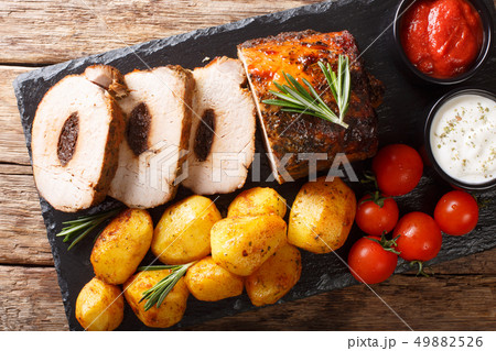 Festive baked pork stuffed with prunes with new 49882526