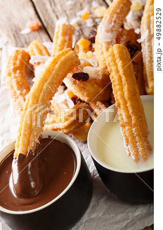 Deep-fried sweet churros served with hot chocolate 49882529