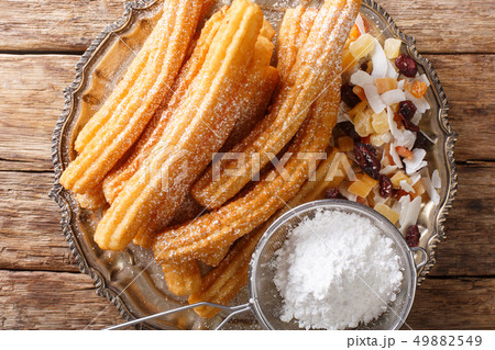 Churros are a golden and crispy fried pastries Churros are a golden and crispy fried pastries 49882549