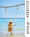 Women sitting on the beach swing, Koh Mak 49882559