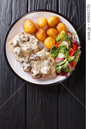 Pork steak in creamy mushroom sauce with a side Pork steak in creamy mushroom sauce with a side 49882770