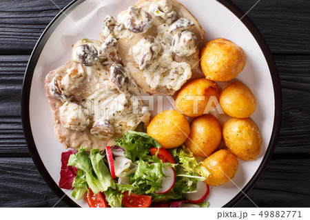 Portion of pork steak in a creamy mushroom sauce 49882771