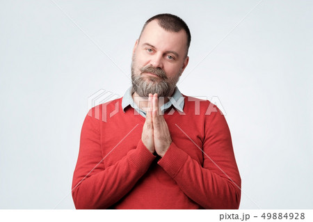 Hopeful man join hands in prayer asking for help 49884928