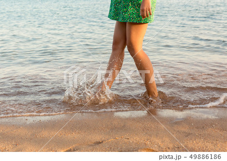 Leg of woman running on beach with water 49886186