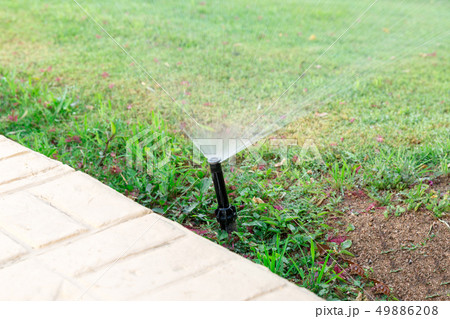 Sprinkler in garden watering the lawn. Automatic Sprinkler in garden watering the lawn. Automatic 49886208