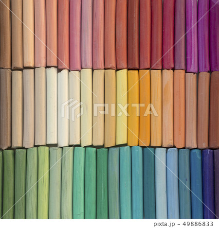 Rainbow pastel crayons in rows as background. Rainbow pastel crayons in rows as background. 49886833